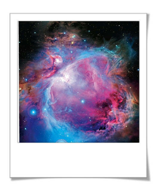 Photograph of Orions Nebula with pink and blue colours