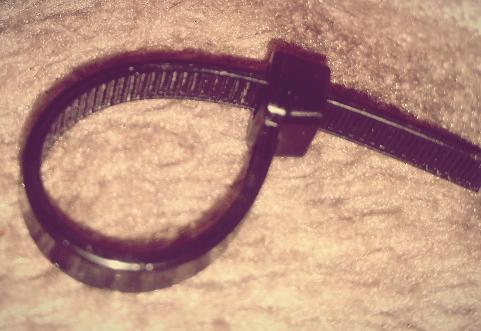 Photograph of a cut of piece of black tie we wrap 