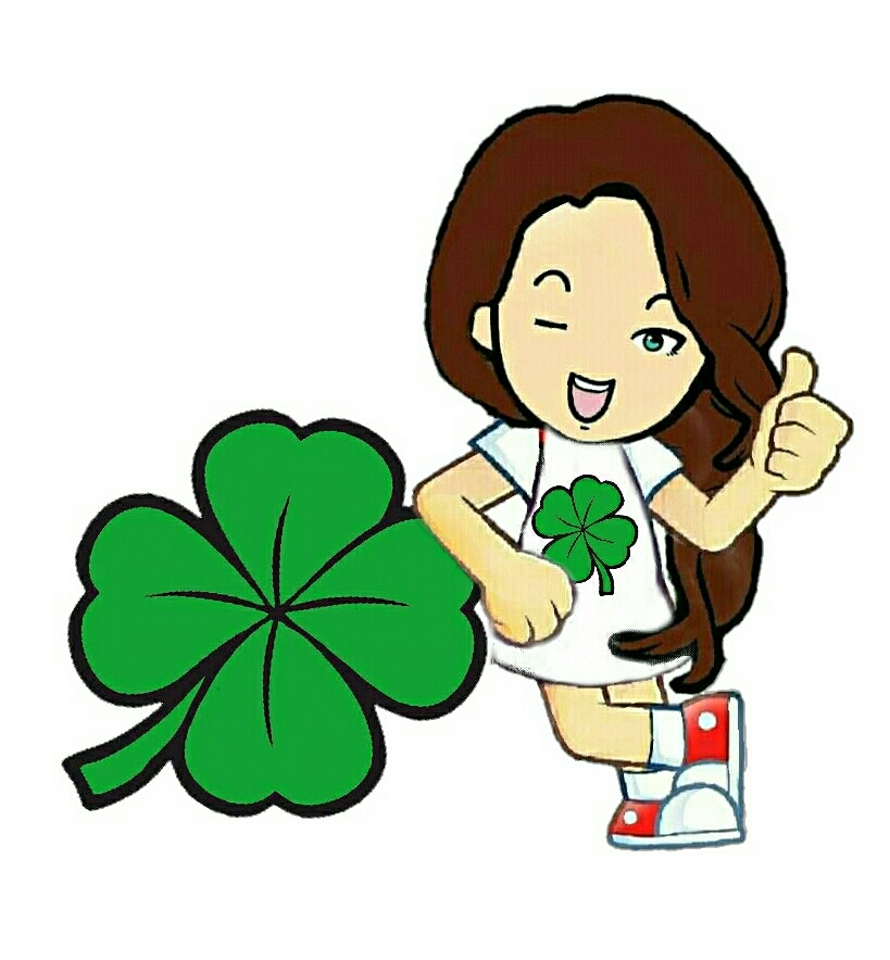 Woman stood next to a large four leaf cloverleaf winking and with a thumbs up 