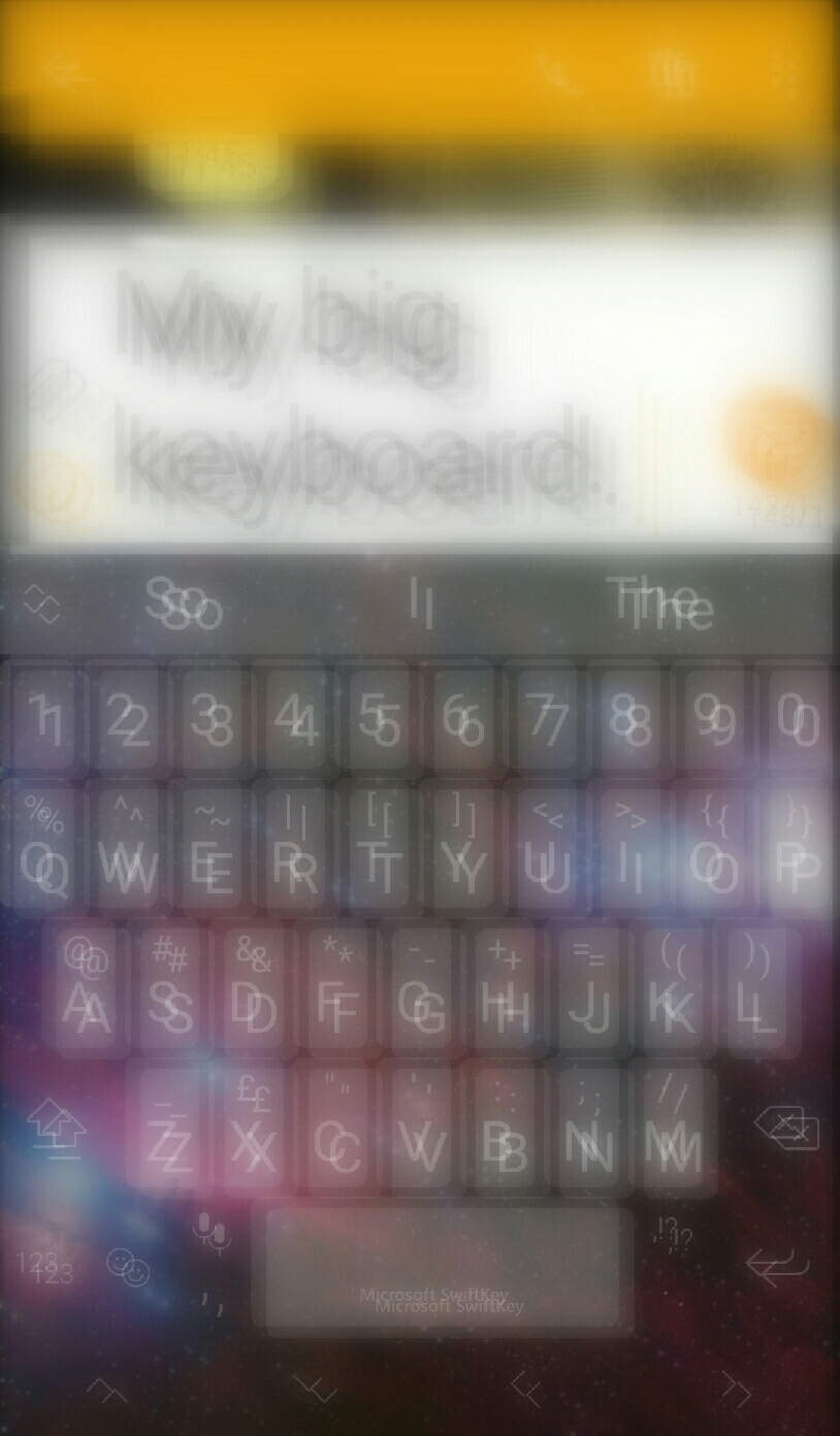 Photograph of the keyboard of myself phone depicting what I see without glasses. This is very blurry 