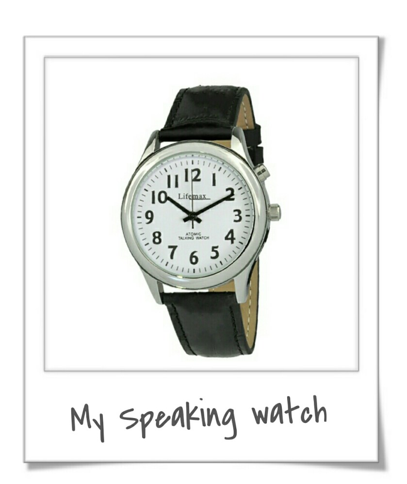 Photograph of a black strapped watch with white face 