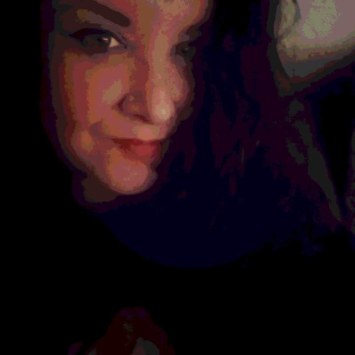 Picture of me with long brown hair looking to camera 